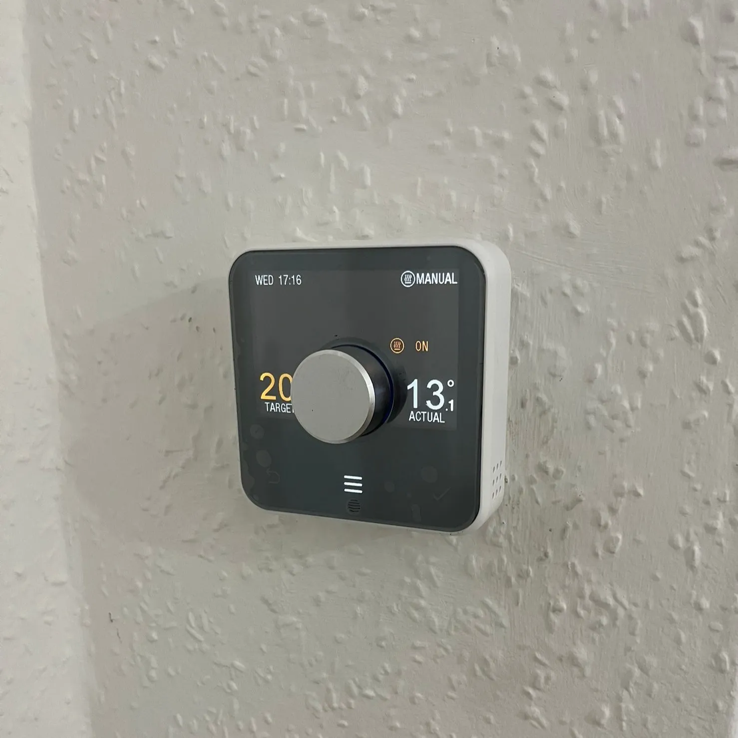 PW-20-Boiler-Thermostat Smart thermostat mounted on a textured wall