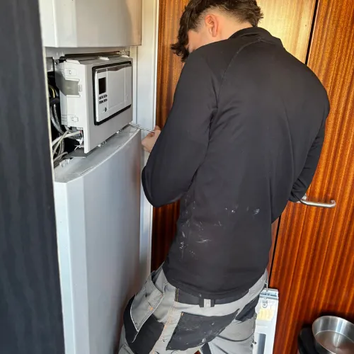 Engineer servicing a Vaillant gas boiler in Perth